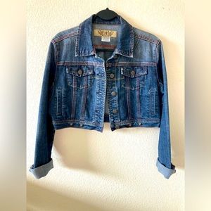 Cropped denim jacket w/ small edgy studs. Red & yellow stitching. Distressed